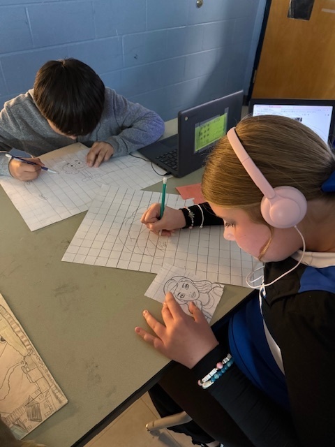 Ms. Patrick's art students using the grid method to enlarge a carton character.