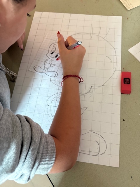 Ms. Patrick's art students using the grid method to enlarge a carton character.