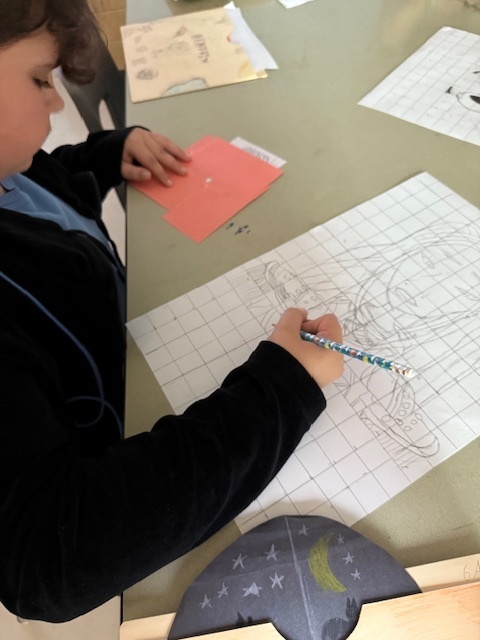 Ms. Patrick's art students using the grid method to enlarge a carton character.