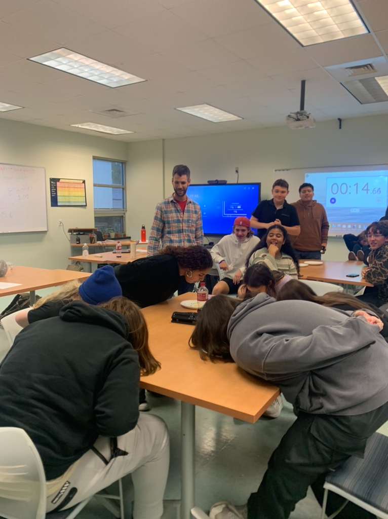 PECHS students eating cookies without their hands