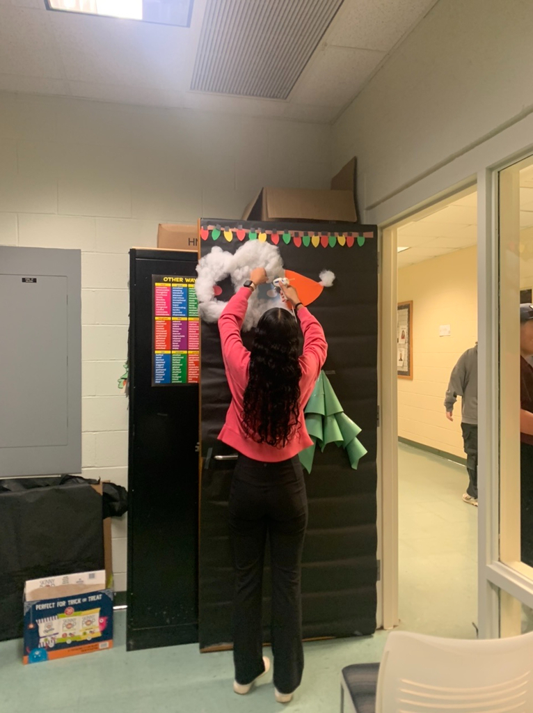 PECHS student decorating a door