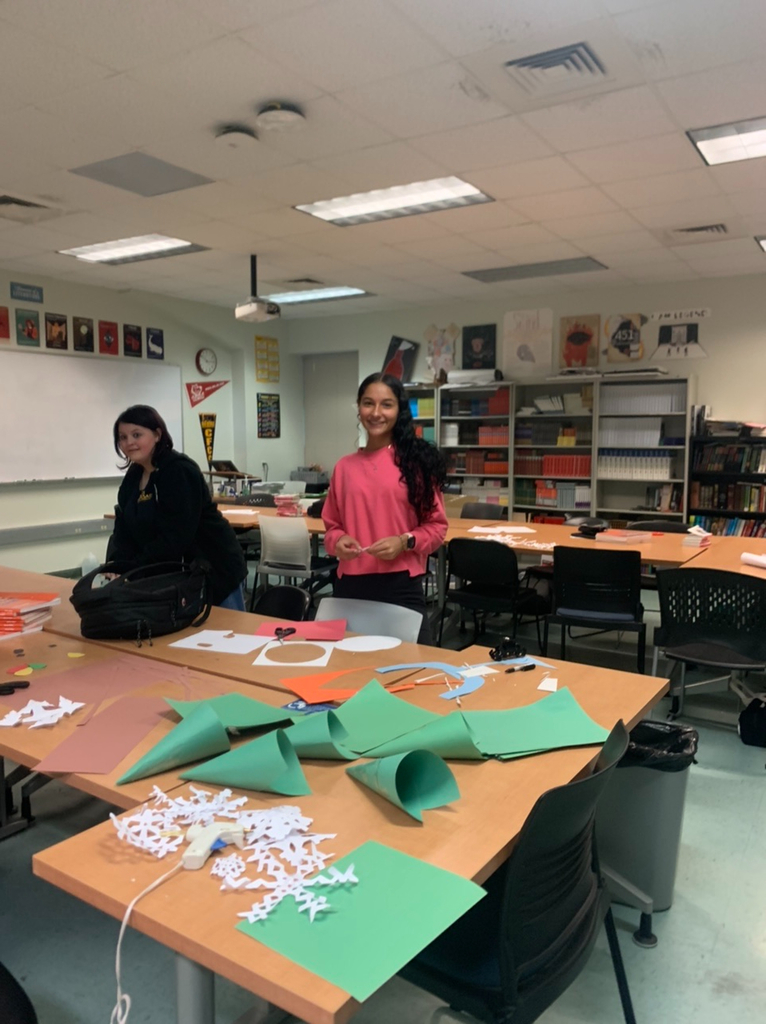 PECHS students cutting materials to put on the door