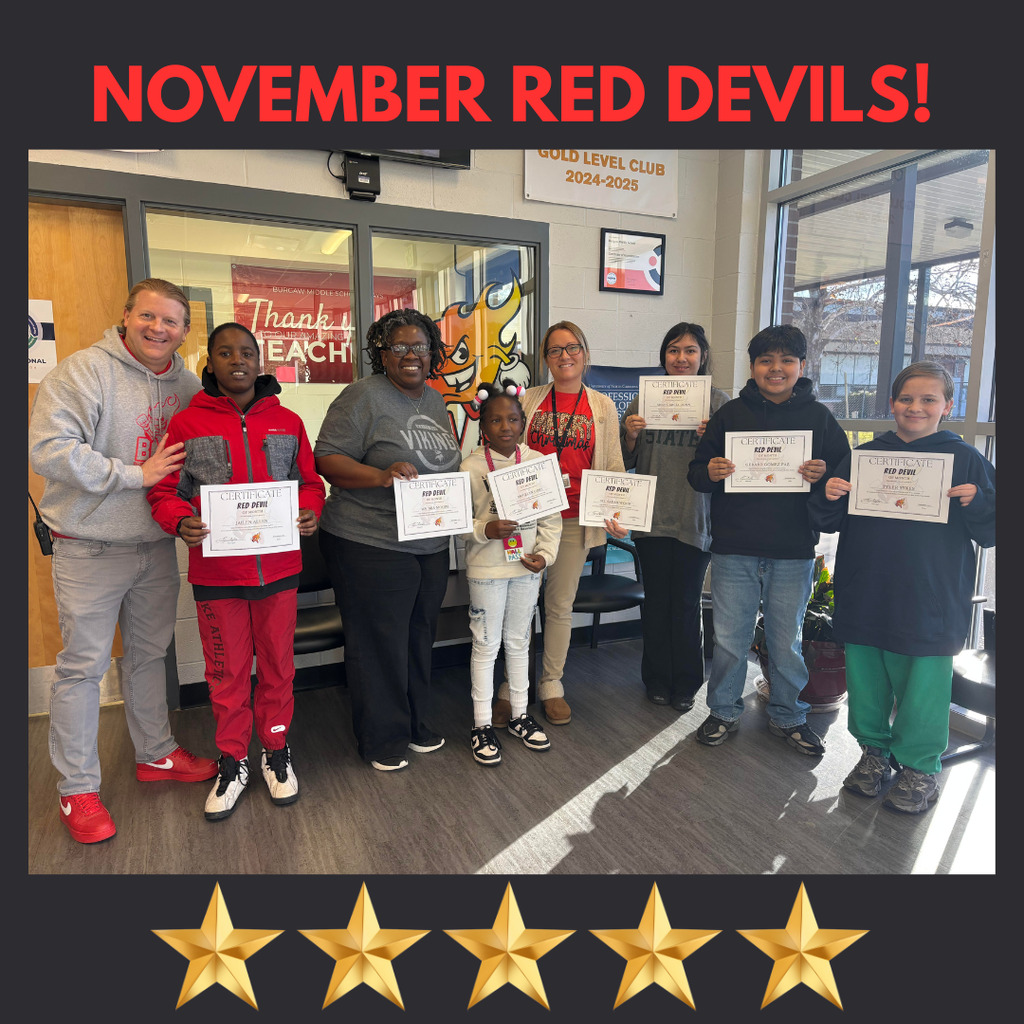 November Red Devils posing in front office of school