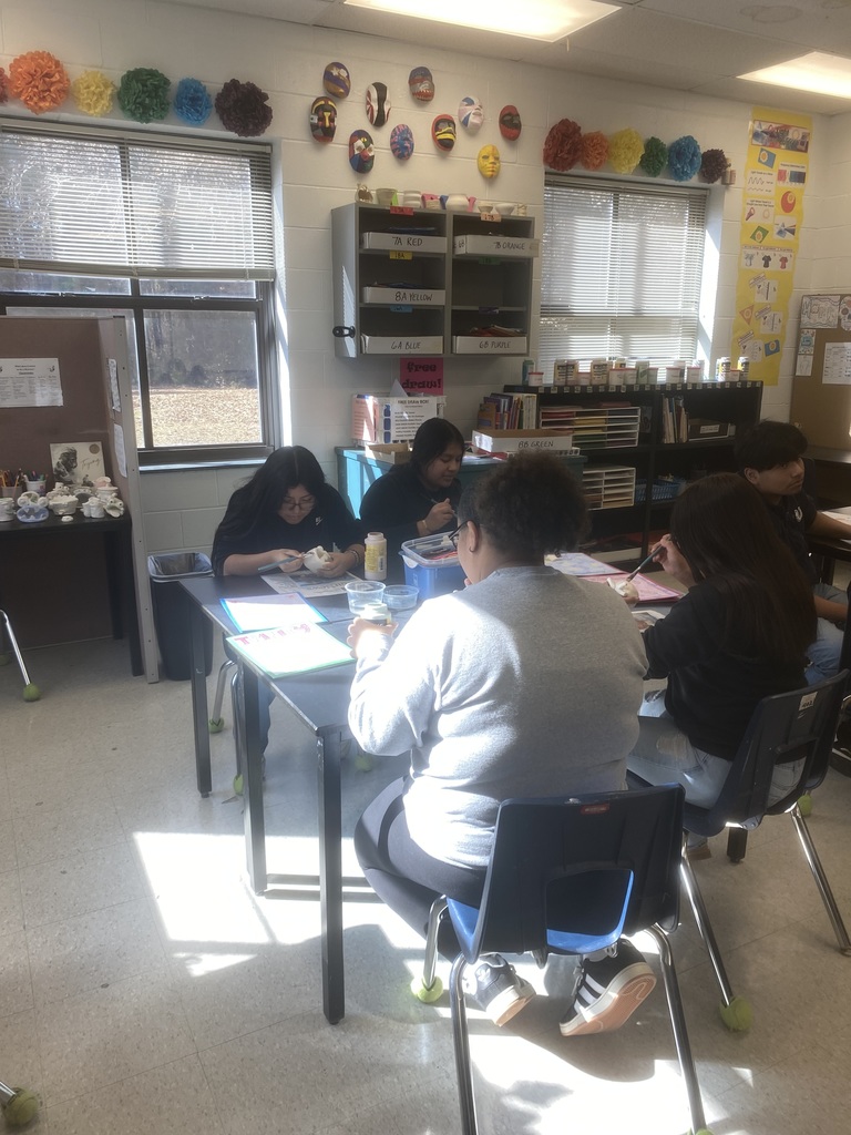 Painting their clay pieces