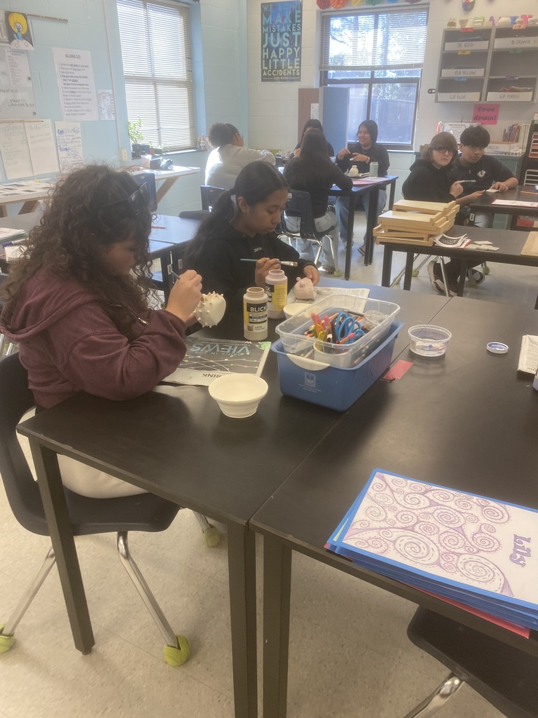 Painting their clay pieces