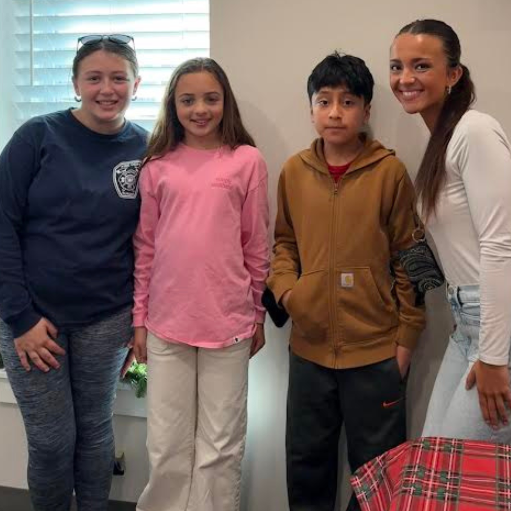 student volunteers posing with teacher