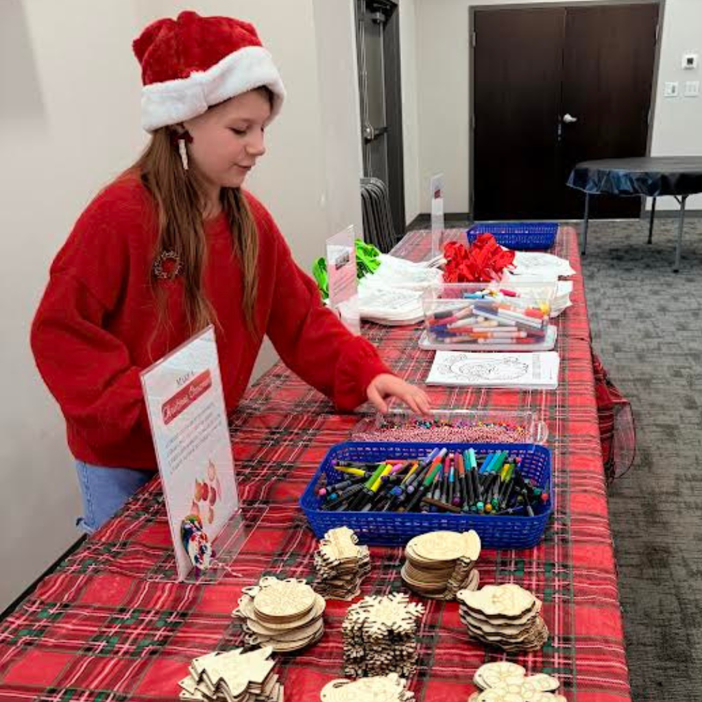 student in holiday gear volunteering