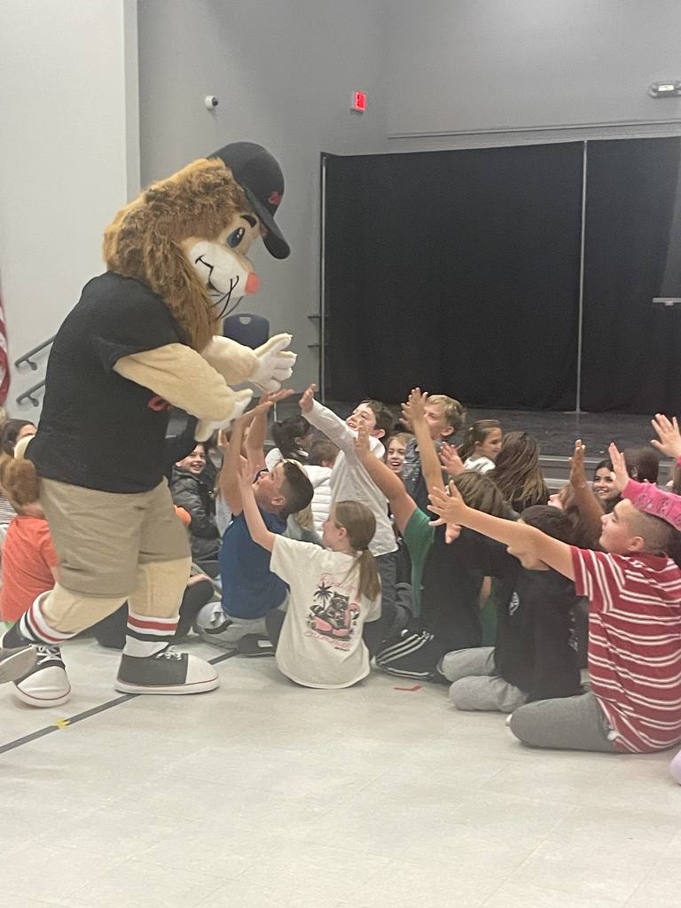 5th grader students sitting in the gym listening to the DARE program