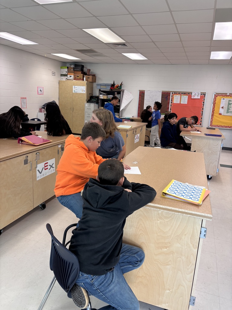 In Mrs. Morin's class, students practiced cooperative drawing with holiday themes. The challenge: draw collaboratively, one shape at a time, with no verbal communication.