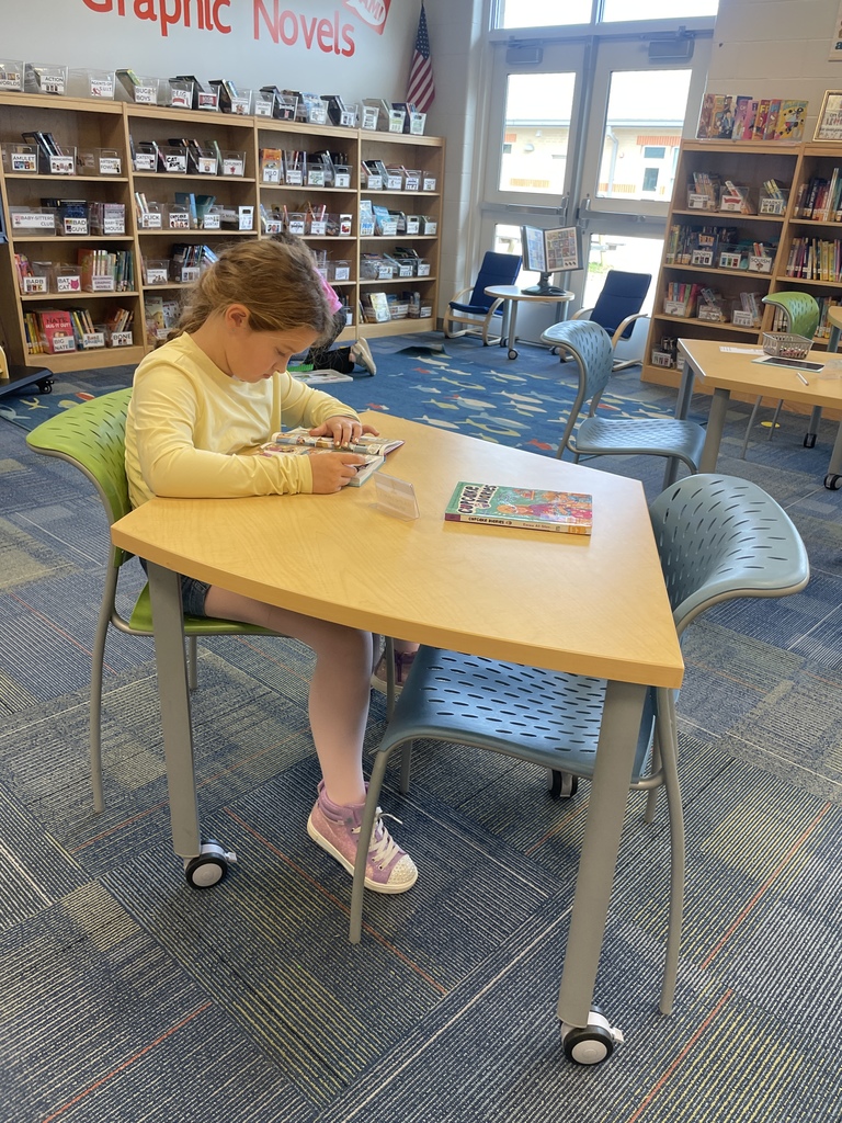 1st grade student reading a book