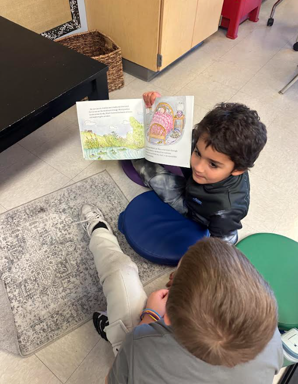 1st graders working in partners on a picture walk in a book