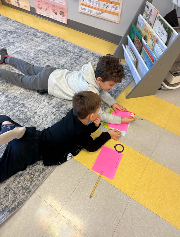1st graders working in partners on a picture walk in a book