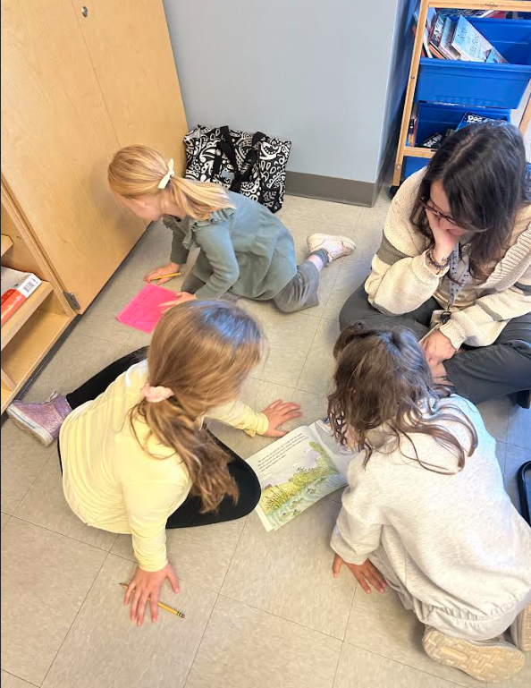 1st graders working in partners on a picture walk in a book