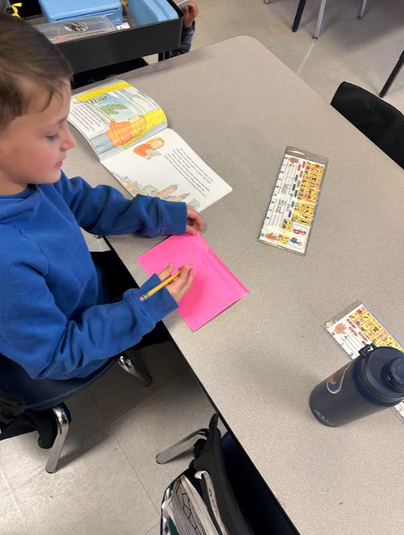 1st graders working in partners on a picture walk in a book
