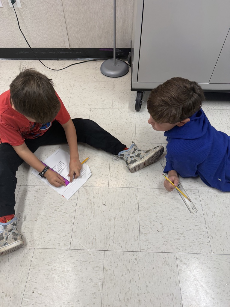 3rd graders working on a measurement activity 