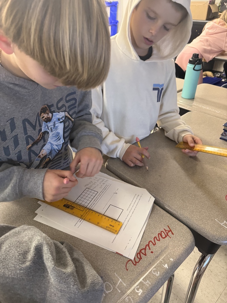 3rd graders working on a measurement activity 