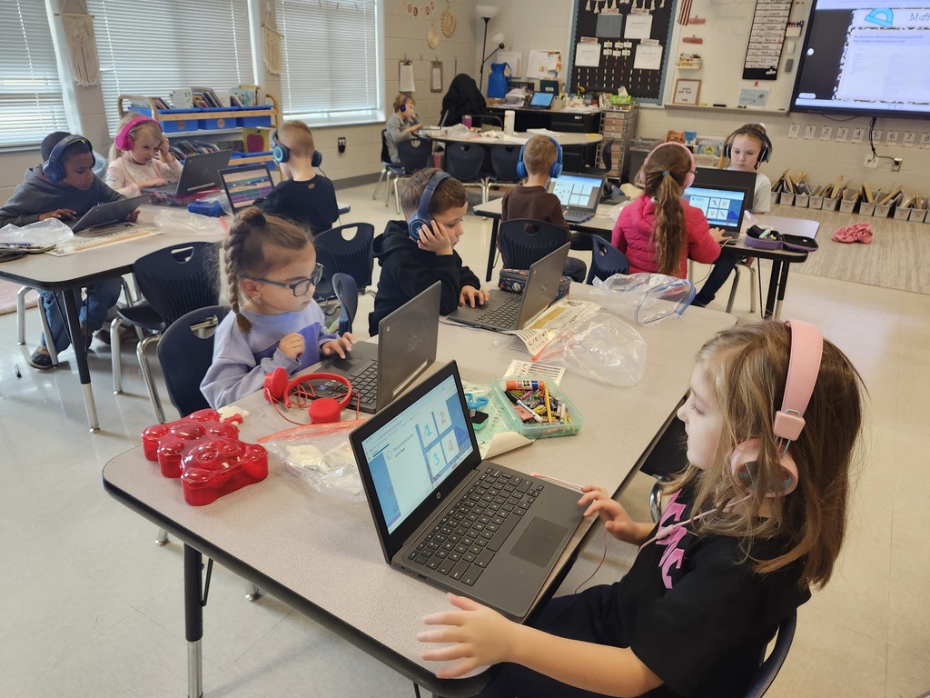 Kindergarten students sitting at their tables working on their Freckle math program