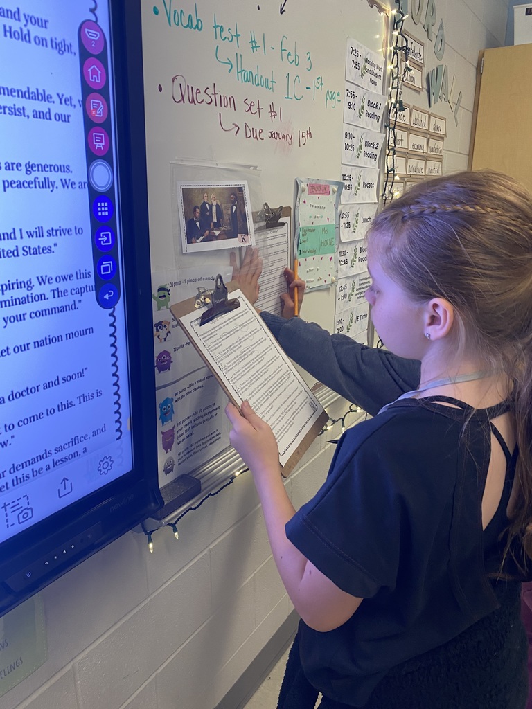 5th graders working in groups on a ELA project