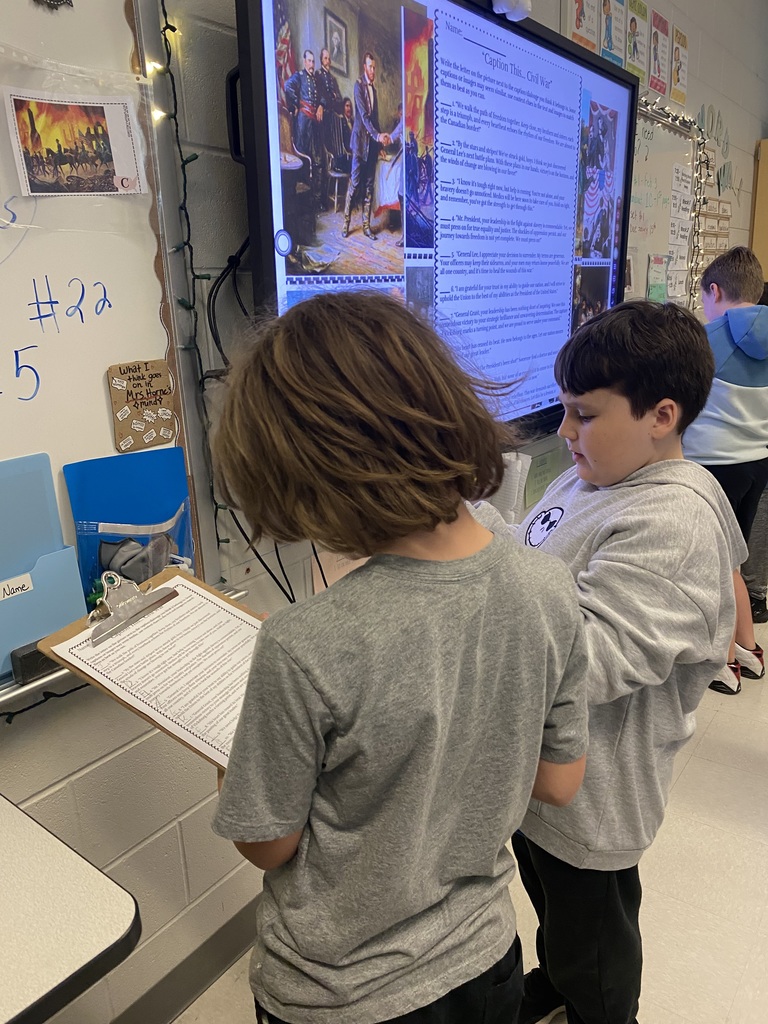 5th graders working in groups on a ELA project