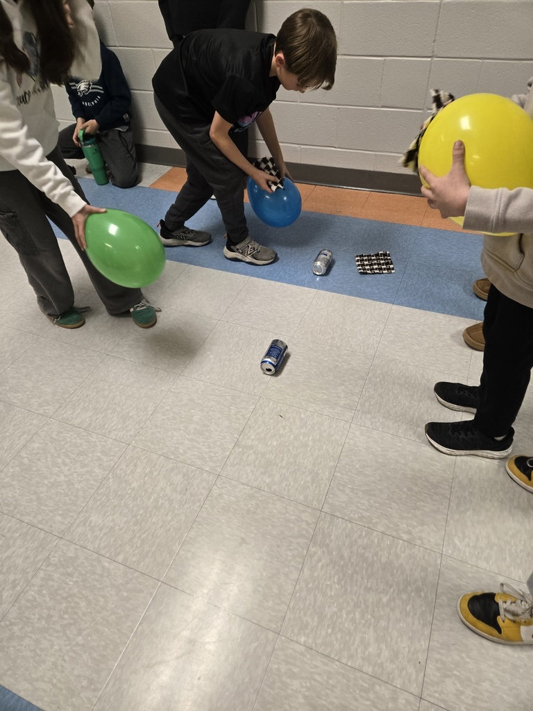 3rd graders using a balloon and static electricity to move an empty can