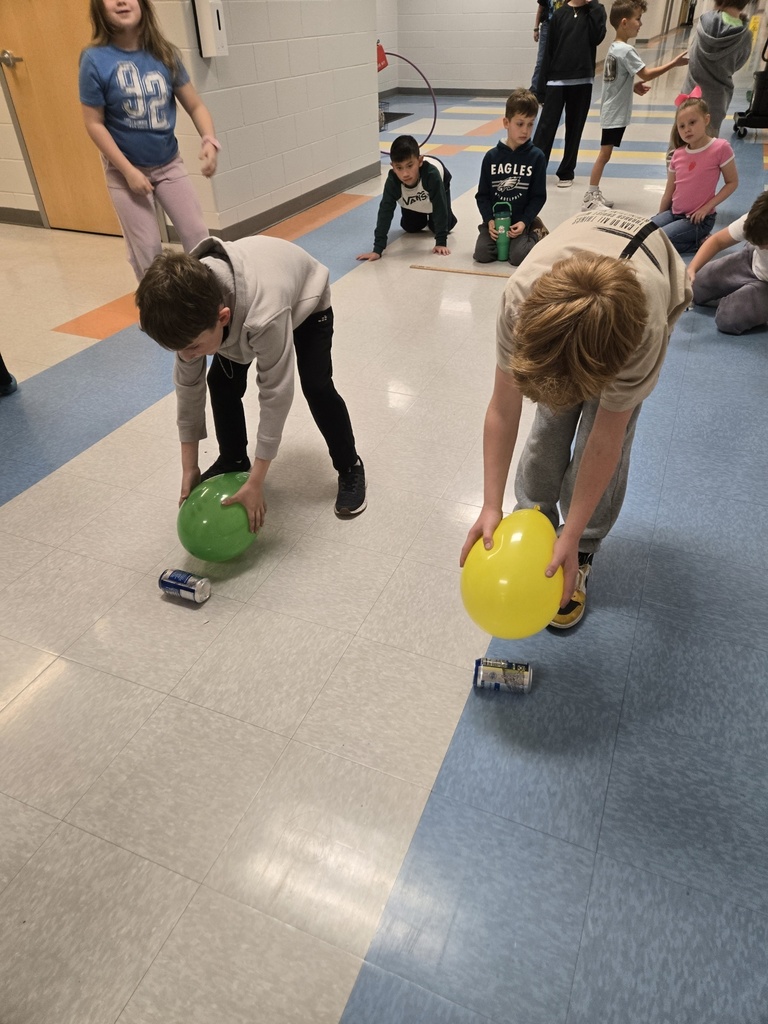 3rd graders using a balloon and static electricity to move an empty can