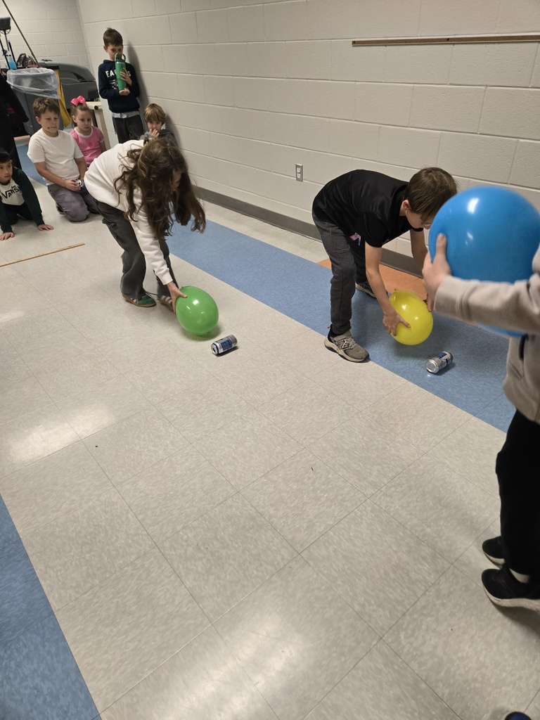 3rd graders using a balloon and static electricity to move an empty can