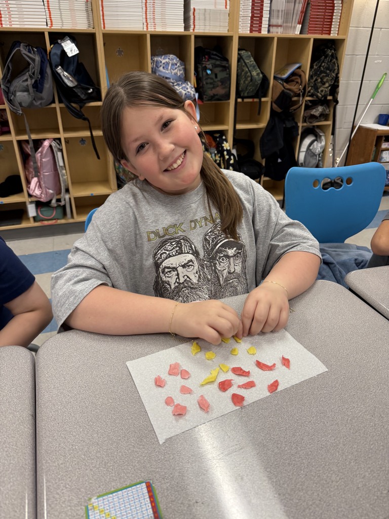 students working with unwrapped starbusts at their desk