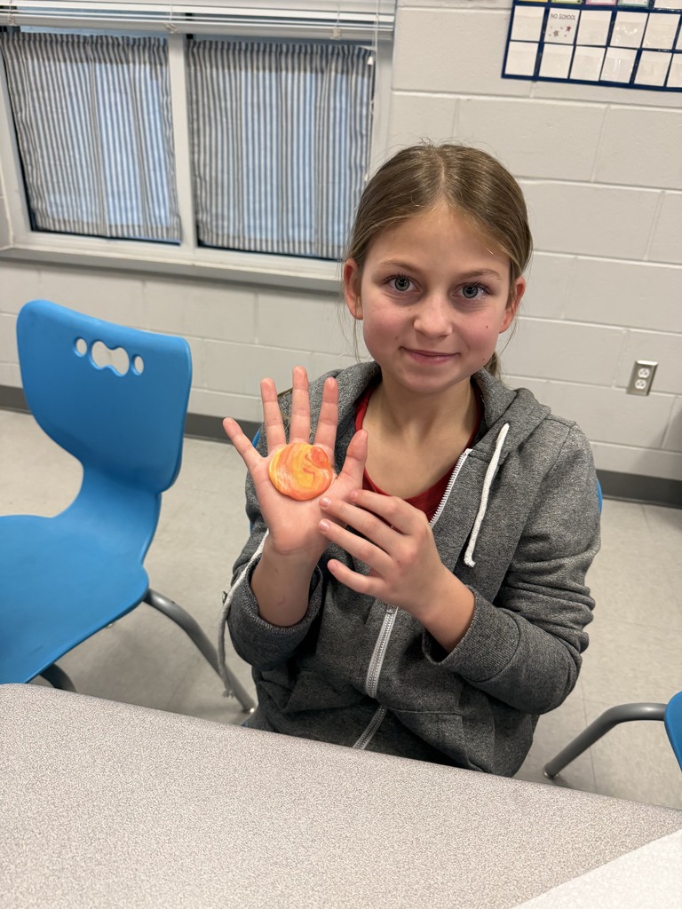 students working with unwrapped starbusts at their desk