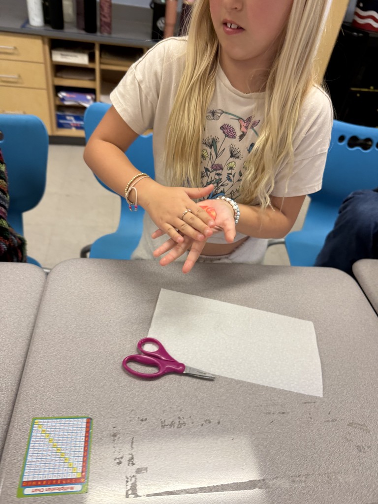 students working with unwrapped starbusts at their desk