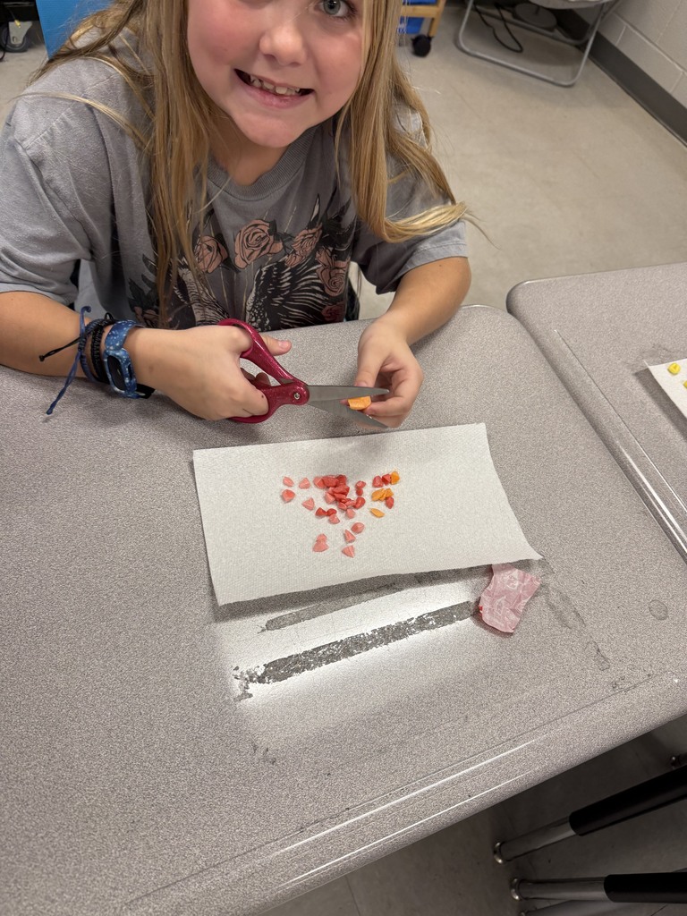 students working with unwrapped starbusts at their desk