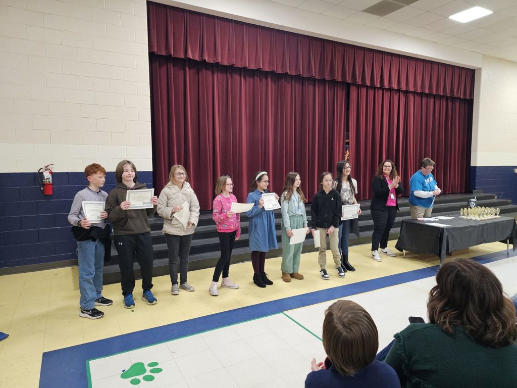 SCE students standing on stage at district science fair competition