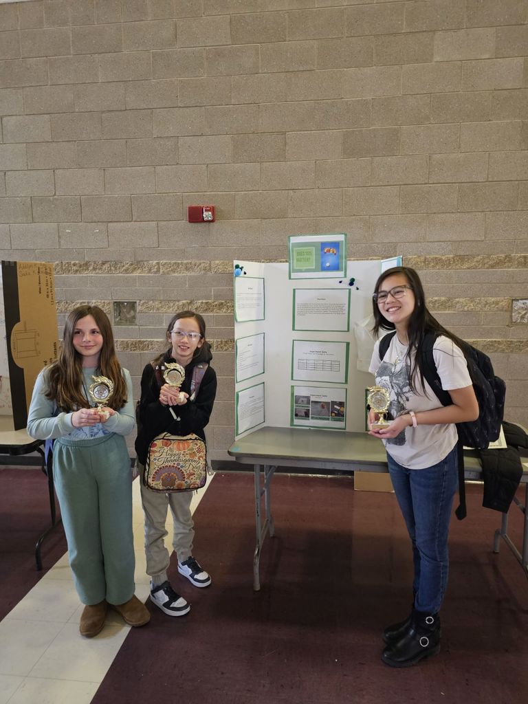 SCE students standing on stage at district science fair competition