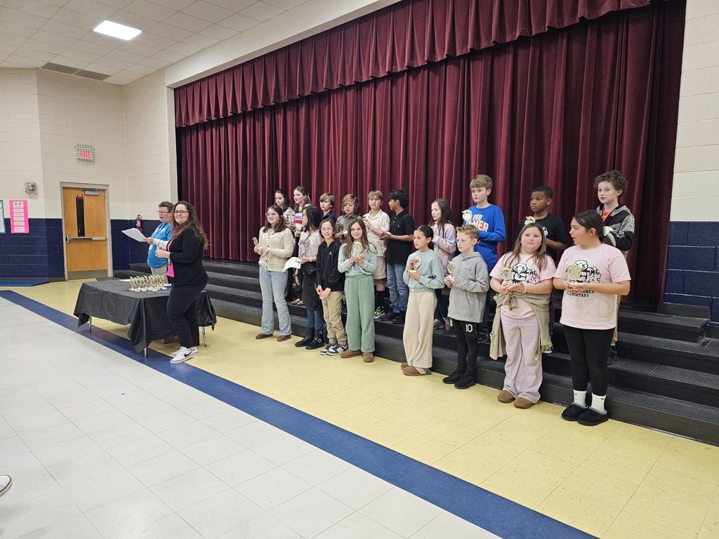 SCE students standing on stage at district science fair competition