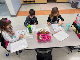first graders working on math activity at their table