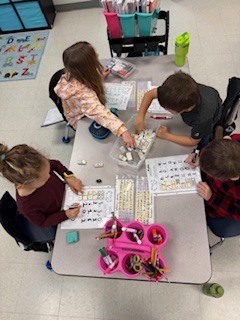 first graders working on math activity at their table