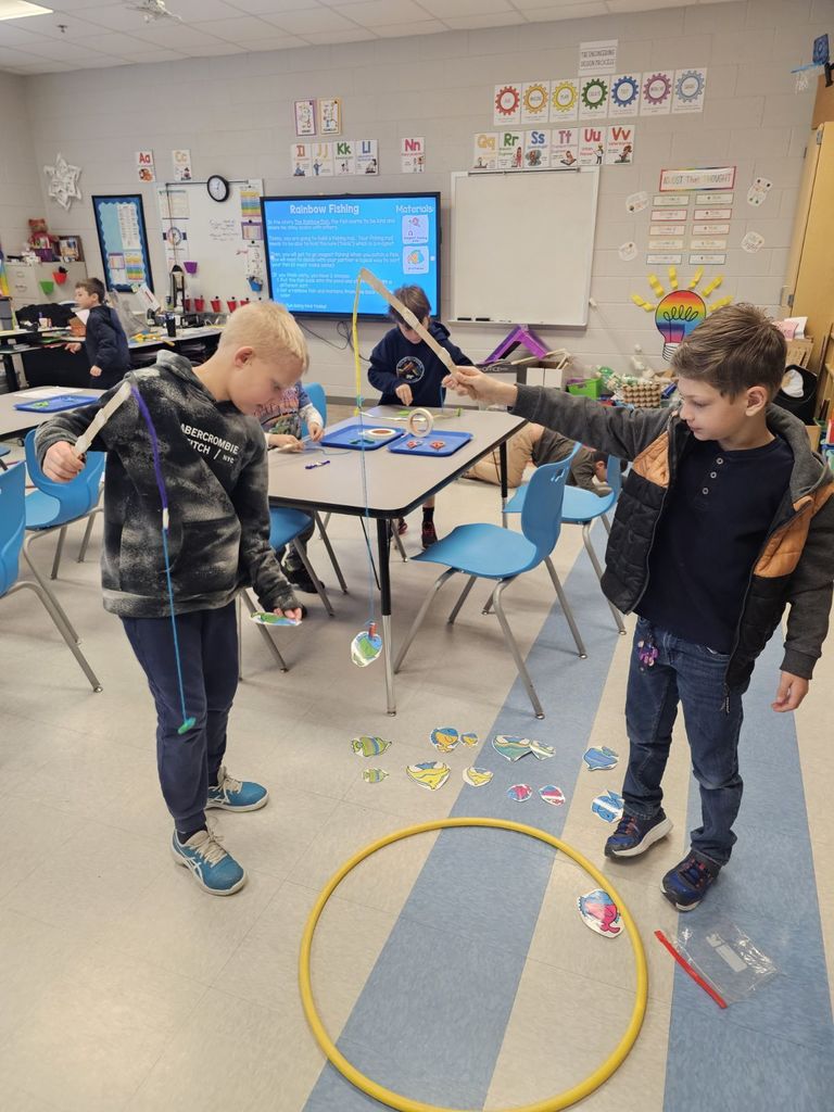 students in STEAM class using a fishing pole with a magnet to collect fish