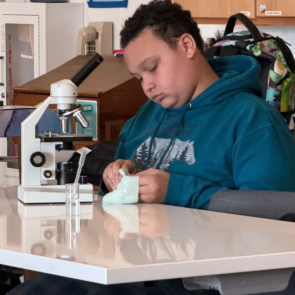 student with microscope