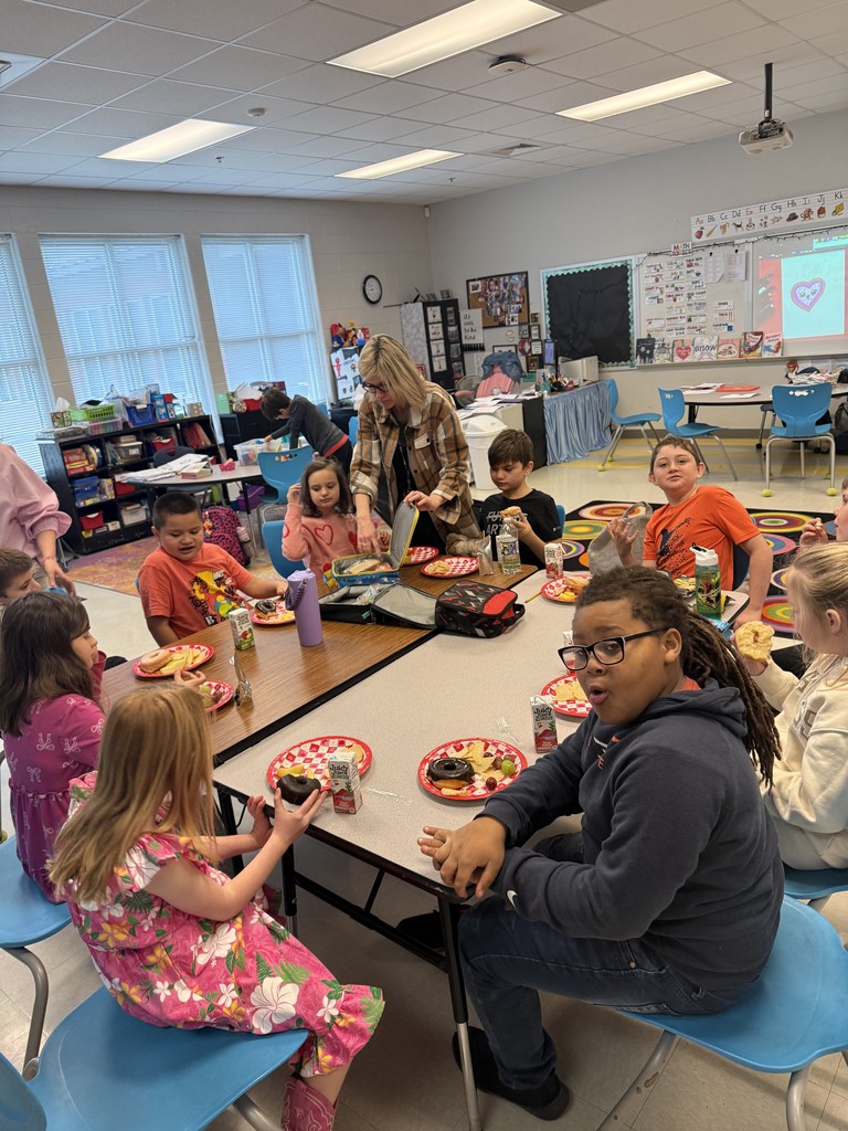 students working on a valentine's activity at their table