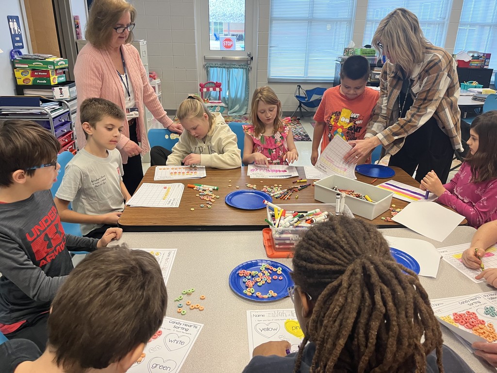 students working on a valentine's activity at their table