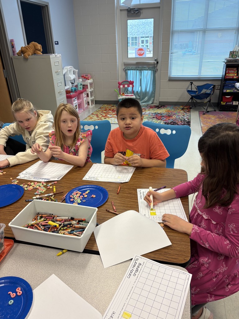 students working on a valentine's activity at their table