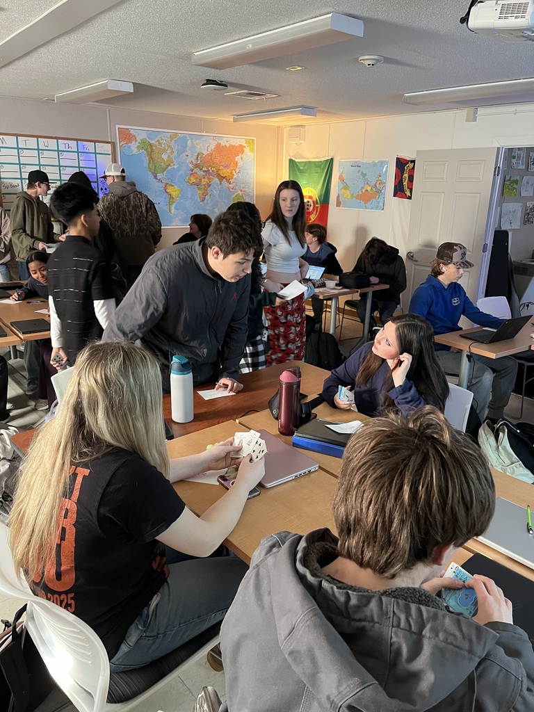 Student traded playing cards with each other to get items needed for their social classes. 