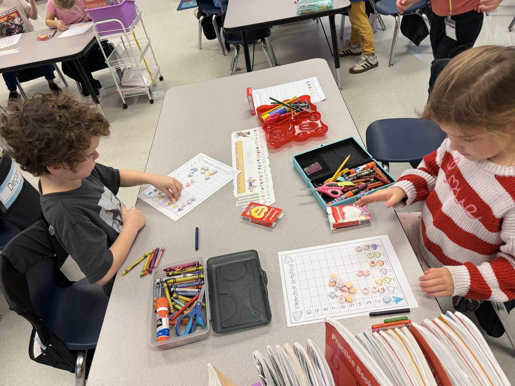 first graders working on a valentine's graphing activity
