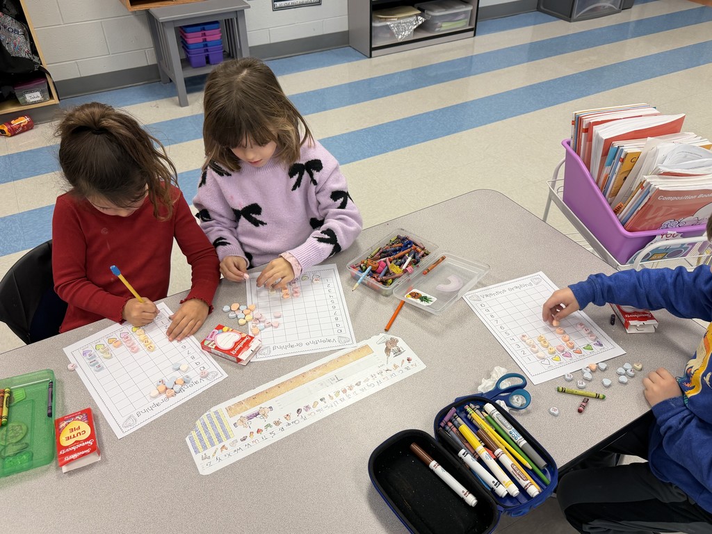 first graders working on a valentine's graphing activity