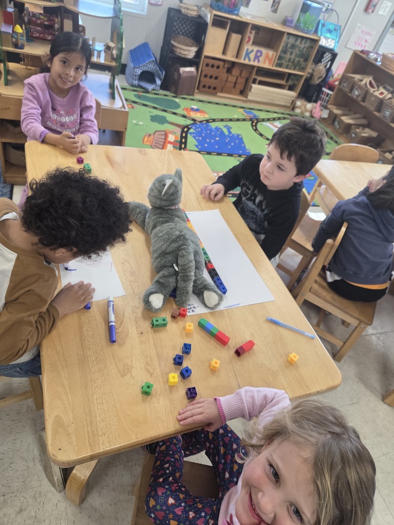 PreK kids measuring classroom items