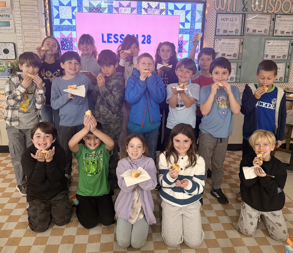 3rd graders all holding up their projects