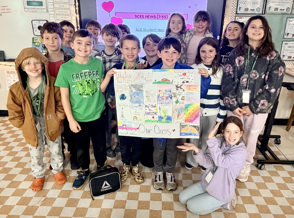 3rd grade holding up their paper quilt 