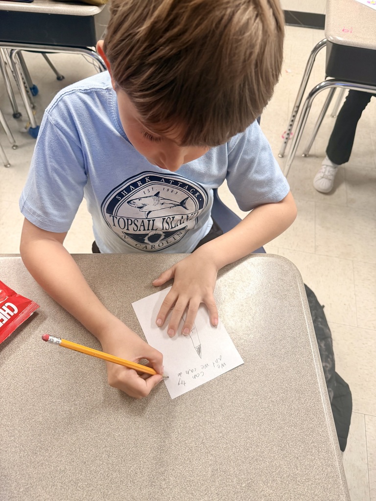 3rd grader working on an art square 