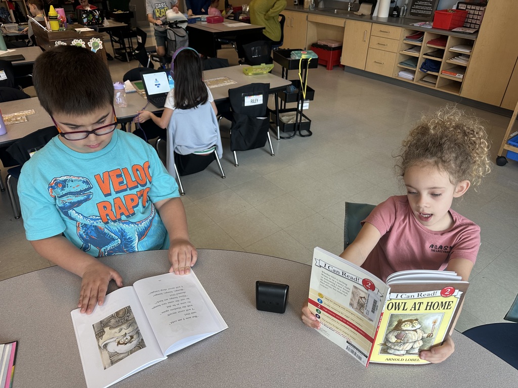 1st graders reading at a table