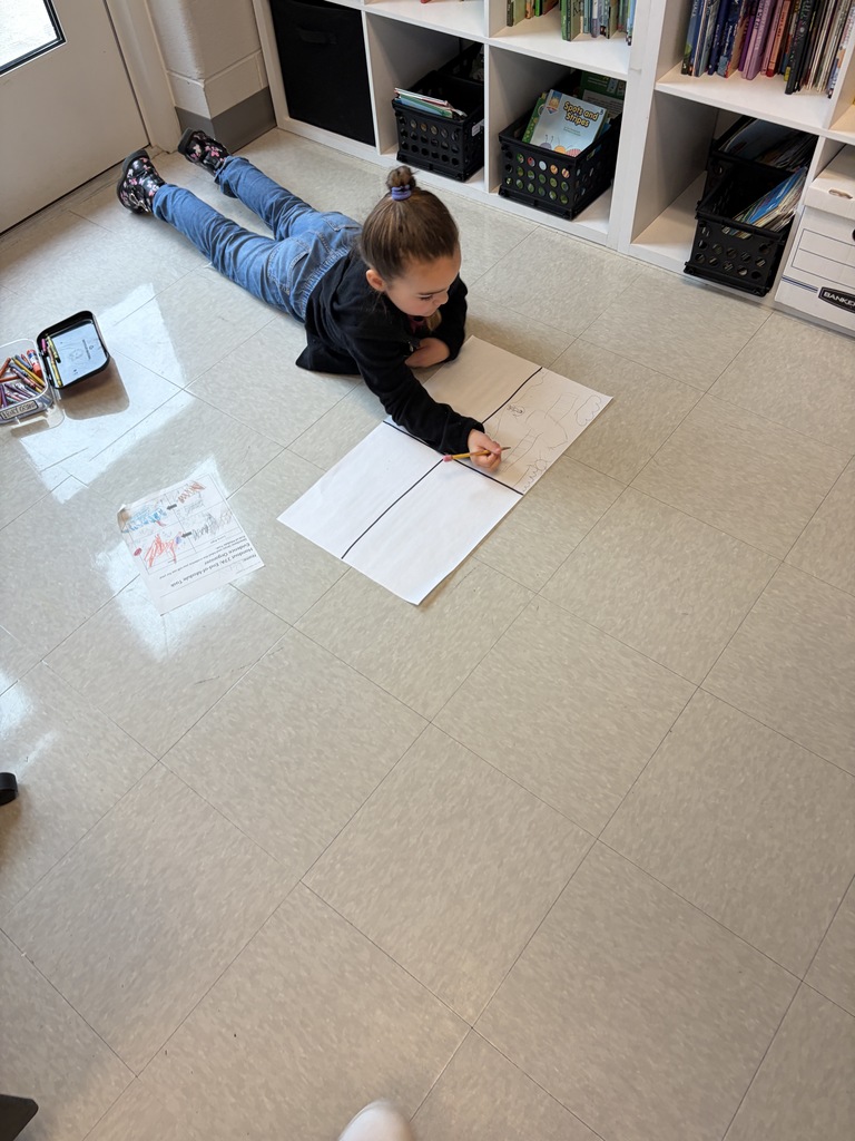 Kindergarten kid working a project at their desk