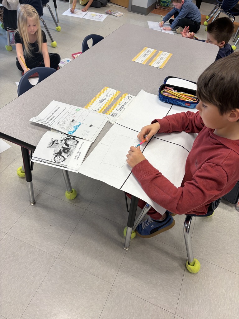 Kindergarten kid working a project at their desk